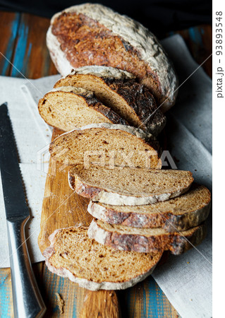 Freshly baked bread with a golden crust close up. Freshly baked bread with a golden crust close up. 93893548