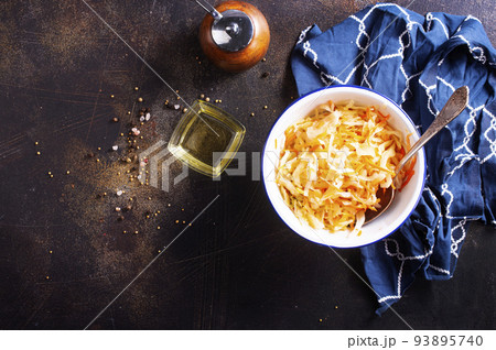 Sauerkraut in a white plate. Homemade sauerkraut with carrot . Fermented food. Natural probiotic. Copy space for text Sauerkraut in a white plate. Homemade sauerkraut with carrot . Fermented food. Natural probiotic. Copy space for text 93895740
