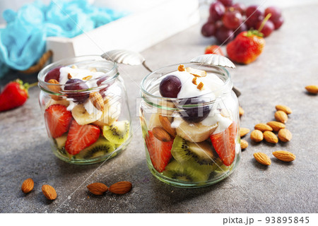 Summer fruit salad with white cream and almonds Summer fruit salad with white cream and almonds 93895845