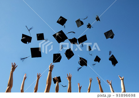 Graduation Caps Thrown in the Air on blue sky Graduation Caps Thrown in the Air on blue sky 93896698