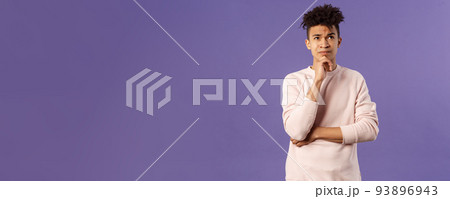 Portrait of complicated, young thoughtful man with dreads, look troubled up, thinking what to do, standing indecisive, grimacing not knowing answer, facing hard choices, purple background Portrait of complicated, young thoughtful man with dreads, look troubled up, thinking what to do, standing indecisive, grimacing not knowing answer, facing hard choices, purple background 93896943