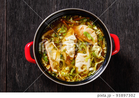 Asian Potsticker Soup in red pot, top view Asian Potsticker Soup in red pot, top view 93897302