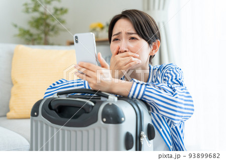 旅行の準備をするミドル女性(スマホ・予約・キャンセル・問題) 旅行の準備をするミドル女性(スマホ・予約・キャンセル・問題) 93899682