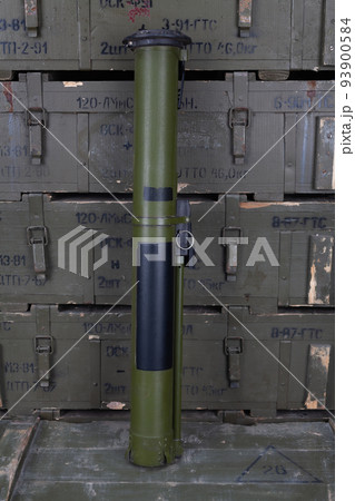 RPG anti-tank rocket propelled grenade launcher with HEAT grenade on army green crate. Text in russian - type of ammunition, projectile caliber, projectile type, number of pieces and weight. 93900584