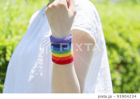 屋外で虹色のリストバンドをした女性 屋外で虹色のリストバンドをした女性 93904234