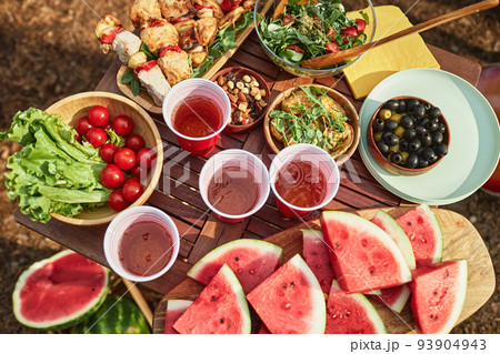 Picnic with fruits and meat outdoors Picnic with fruits and meat outdoors 93904943