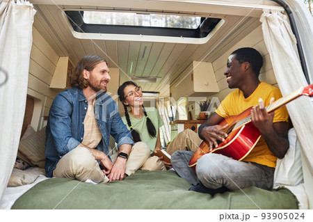 Friends playing guitar and singing songs Friends playing guitar and singing songs 93905024