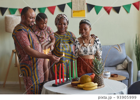 African family celebrating Kwanzaa holiday African family celebrating Kwanzaa holiday 93905999