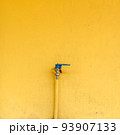 Faucet for water on the yellow wall 93907133