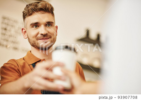 Portrait of smiling coffeeshop barista giving cup of coffee to customer Portrait of smiling coffeeshop barista giving cup of coffee to customer 93907708