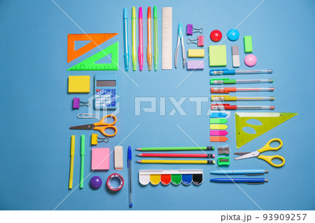 Calculator, stationery accessories on blue background with copy space. Look 93909257