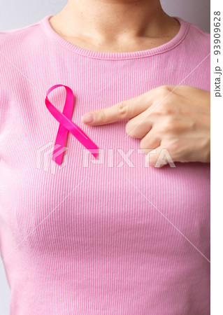 Pink October Breast Cancer Awareness month, woman hand hold pink Ribbon and wear shirt for support people life and illness. National cancer survivors month, Mother and World cancer day concept Pink October Breast Cancer Awareness month, woman hand hold pink Ribbon and wear shirt for support people life and illness. National cancer survivors month, Mother and World cancer day concept 93909628