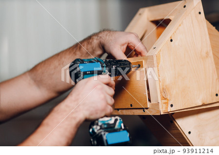 Artisan craftsman carpenter sculptor frame wooden create carcass framework. Wooden board, plywood and screwdriver Artisan craftsman carpenter sculptor frame wooden create carcass framework. Wooden board, plywood and screwdriver 93911214