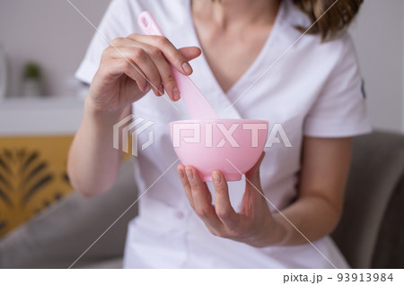A container for preparing masks in the hands of a cosmetologist A container for preparing masks in the hands of a cosmetologist 93913984
