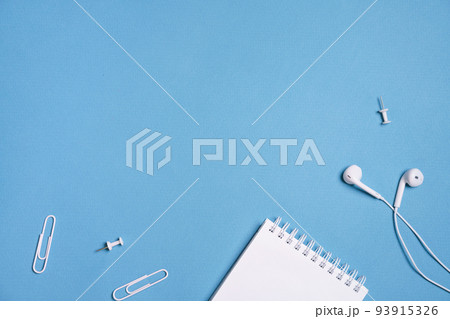 Headphones, open notebook Music concept. Top view with copy space on blue Headphones, open notebook Music concept. Top view with copy space on blue 93915326