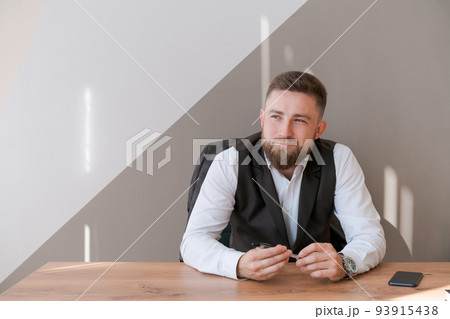 Portrait bearded business man sitting in office meditating holding pen in his 93915438