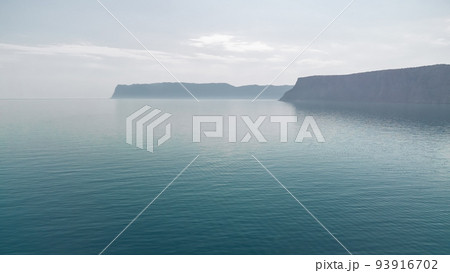 Aerial panoramic view of seascape with crystal clear azure sea and rocky shores. Yachts in a beautiful lagoon on backdrop of rocks. The concept of an ideal destination for summer travel and vacation. 93916702