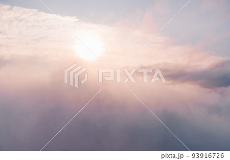 Aerial view. The drone flies over foggy and fluffy clouds. Blue sky sun and sea fog. Abstract aerial nature summer ocean sunset sea and sky background. Vacation, travel and holiday concept Aerial view. The drone flies over foggy and fluffy clouds. Blue sky sun and sea fog. Abstract aerial nature summer ocean sunset sea and sky background. Vacation, travel and holiday concept 93916726
