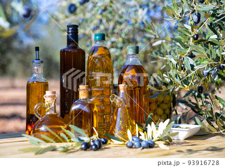 Set of bottles with olive oil on background with olive tree 93916728