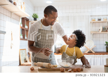 African American Father and son playing in kitchen 93921323