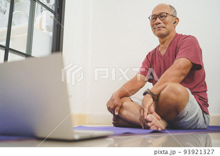 Asian senior man looking while exercises Asian senior man looking while exercises 93921327