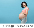 Korean pregnant woman standing on Blue background 93921378
