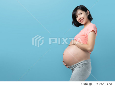 Korean pregnant woman standing on Blue background 93921378