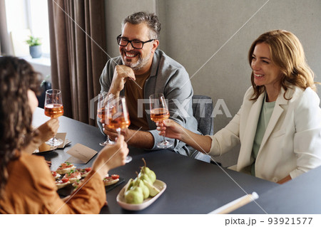 Happy mature parents and two girlfriends with flutes of champagne or wine 93921577