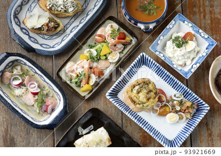 selection of many different tapas on rustic wood table 93921669