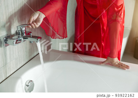 Women prepare for taking a bath 93922162