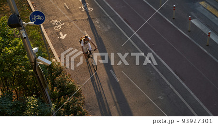 Man bicycling on cycling road. Top aerial view. Man bicycling on cycling road. Top aerial view. 93927301