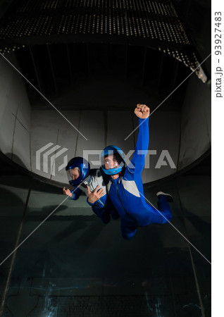 A man teaches a boy to fly in a wind tunnel. Lack of gravity. A man teaches a boy to fly in a wind tunnel. Lack of gravity. 93927483