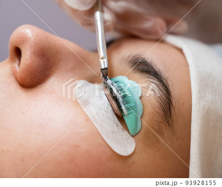 Close-up portrait of a woman on eyelash lamination procedure. Close-up portrait of a woman on eyelash lamination procedure. 93928155
