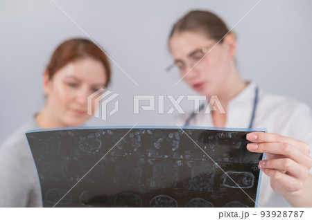 Female doctor explaining mri of internal organs to female patient. Female doctor explaining mri of internal organs to female patient. 93928787