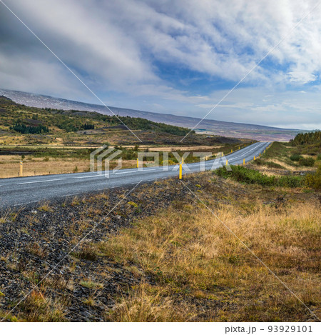 Asphalt road and mountain view during auto trip in Iceland.  Spectacular autumn Icelandic landscape with  scenic nature. 93929101
