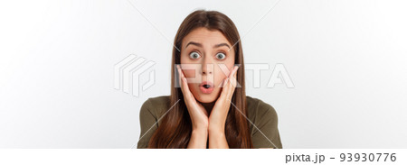 Close-up portrait of surprised beautiful girl holding her head in amazement and open-mouthed. Over white background 93930776