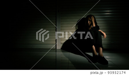 Woman depressed from sad stress pain despair problem, person sit on closed shop on corridor alone with emotion lonely desperate upset head down. Head in hand no way out concept, copy space 93932174