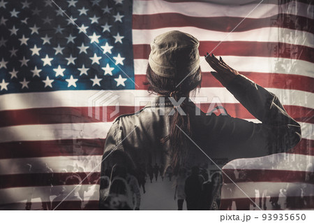 Celebration in the USA. A female soldier saluting, against the background of the American flag. Rear view. Multi-exposure 93935650