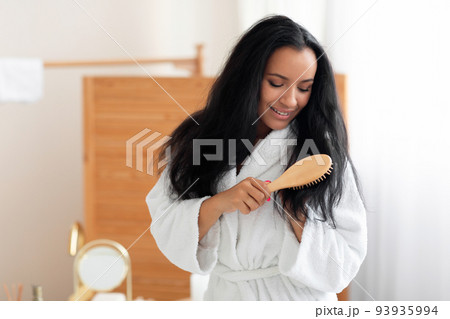 Lady Brushing Long Brunette Hair With Wooden Brush In Bathroom Lady Brushing Long Brunette Hair With Wooden Brush In Bathroom 93935994