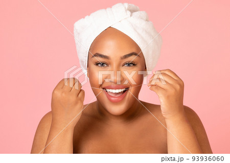 Joyful Black Woman Flossing Teeth Posing Over Pink Background Joyful Black Woman Flossing Teeth Posing Over Pink Background 93936060