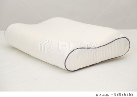 Orthopedic pillow made of memory foam on a white background. A Useful Right Pillow for Healthy Sleep. 93936268