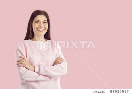 Happy successful young woman arms crossed in front of him, looks at camera and smiling broadly Happy successful young woman arms crossed in front of him, looks at camera and smiling broadly 93936917