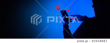 Digital security Concept. Anonymous hacker with mask holding smartphone hacked. Personal and Cyber data security in mobile phone stolen by man in mask. Represent digital privacy protection concept. Digital security Concept. Anonymous hacker with mask holding smartphone hacked. Personal and Cyber data security in mobile phone stolen by man in mask. Represent digital privacy protection concept. 93938887