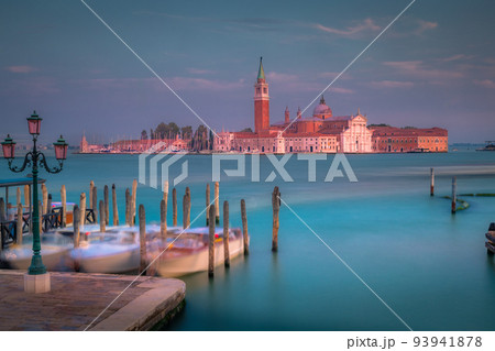 Boats docked by wooden mooring poles in grand canal, Ethereal Venice, Italy 93941878