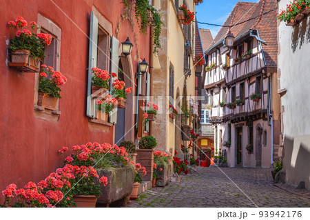 Riquewihr alsatian architecture at springtime with flowers, Eastern France Riquewihr alsatian architecture at springtime with flowers, Eastern France 93942176