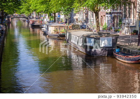 Amsterdam canal with houseboats and dutch architecture, Netherlands 93942350