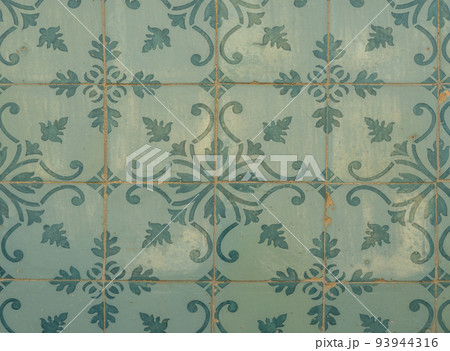 Green ceramic tiles from facade of old houses in Lisbon Portugal. Portuguese traditional Azulejos decorative artistic design background, creative texture surface Green ceramic tiles from facade of old houses in Lisbon Portugal. Portuguese traditional Azulejos decorative artistic design background, creative texture surface 93944316