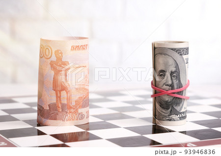 Russian rubles and American dollars on a chessboard Russian rubles and American dollars on a chessboard 93946836