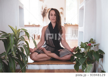 woman practicing yoga lesson, breathing, meditating, doing Padmasana exercise woman practicing yoga lesson, breathing, meditating, doing Padmasana exercise 93948129