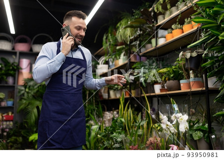 flower shop employee talking on the phone flower shop employee talking on the phone 93950981